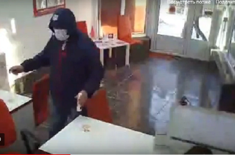 Мужчина ворвался в офис, стал требовать деньги и разливать жидкость для розжига. Фото: кадр видео.