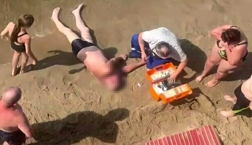 Мужчине на берегу помогали медики.